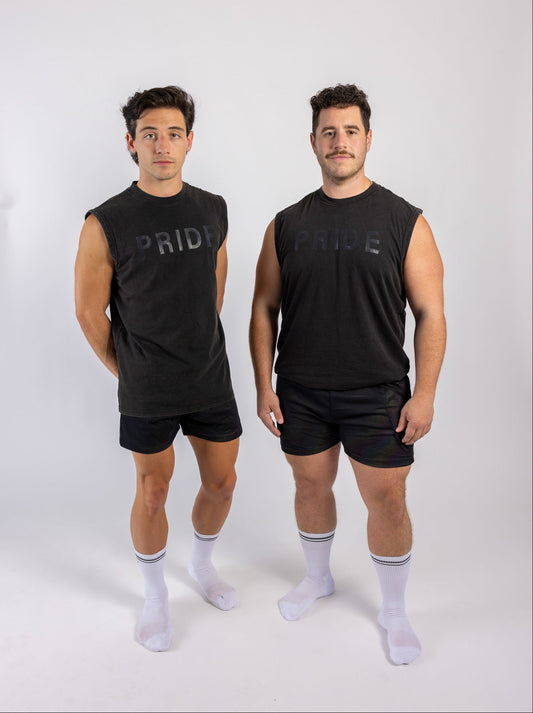Two men wearing black sleeveless shirts with 'PRIDE' text on a white background