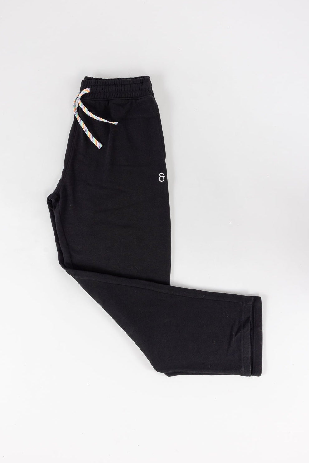 Black pants with a white drawstring on a white background