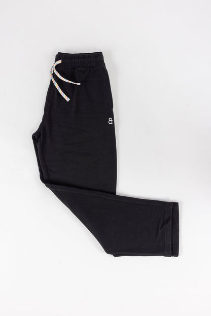 Black pants with a white drawstring on a white background