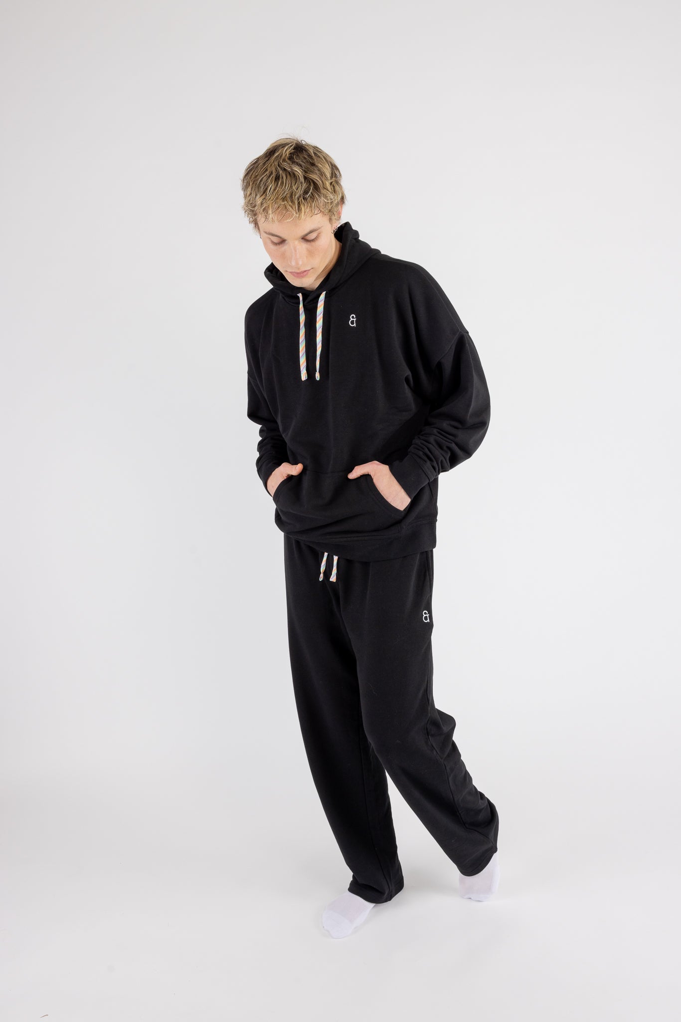 Man wearing the Arco Oversized Hoodie and the Arco Sweatpants by ANDY