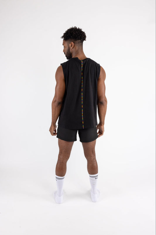 Man wearing a black sleeveless shirt and shorts on a white background