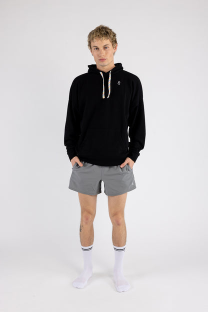 Man wearing the Arco Hoodie and Gray Prism Shorts