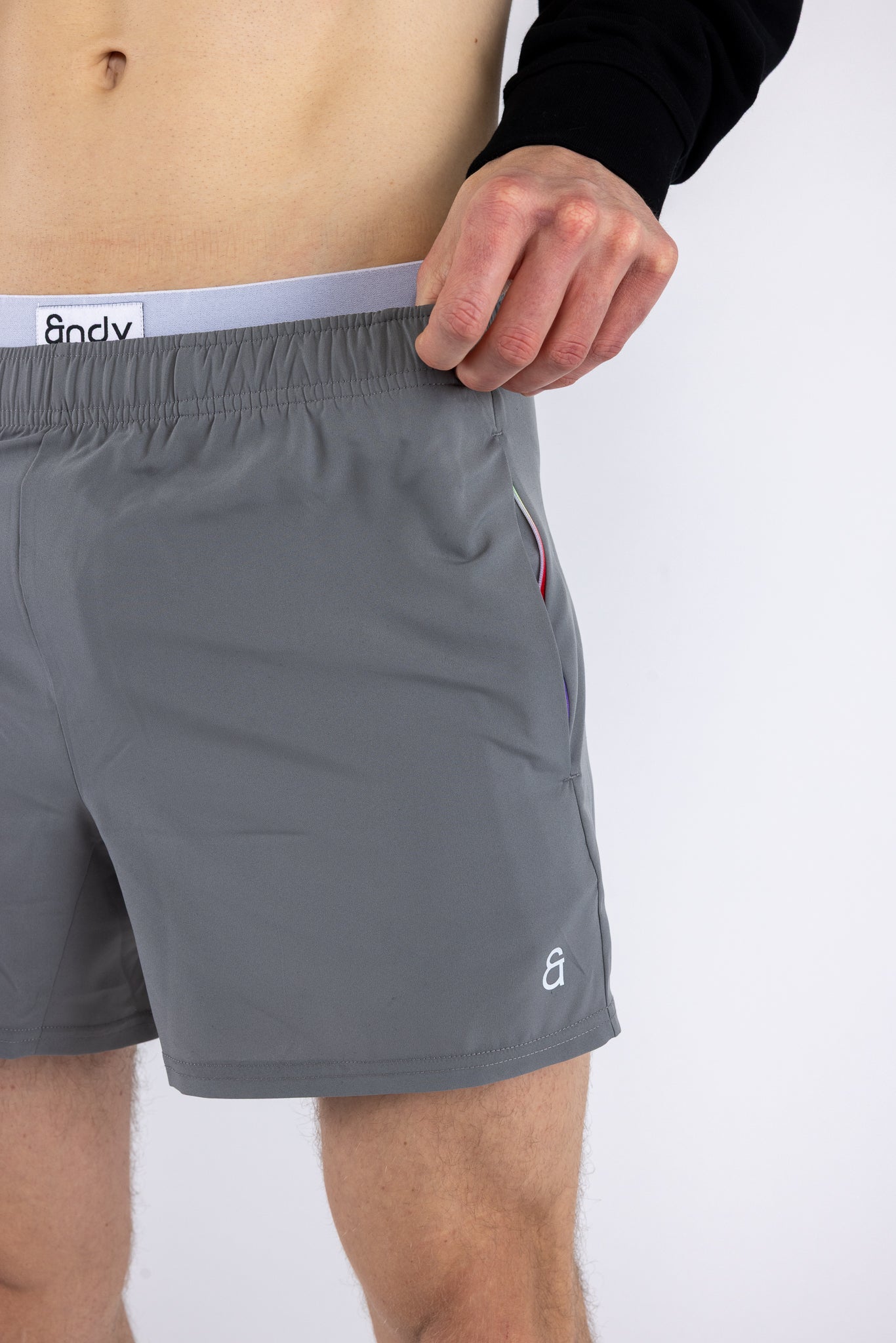 Close up of rainbow gradient pocket detail on gray Andy Prism Shorts