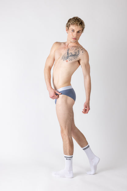 Man wearing a blue thong on a white background
