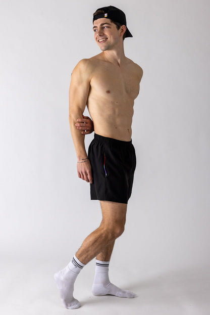 Man wearing Andy Prism Linerless Shorts 4" in Gray on white background