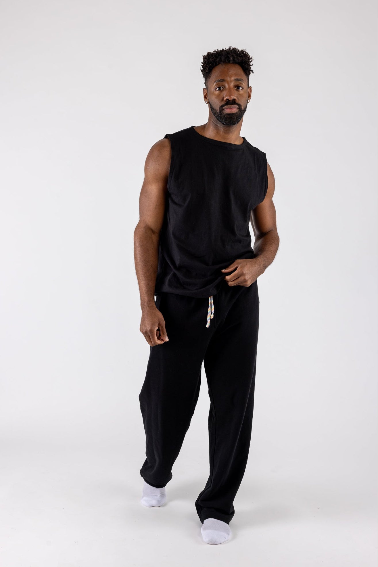 Man wearing Chroma Stitch Tank Top and Arco Sweat Pants