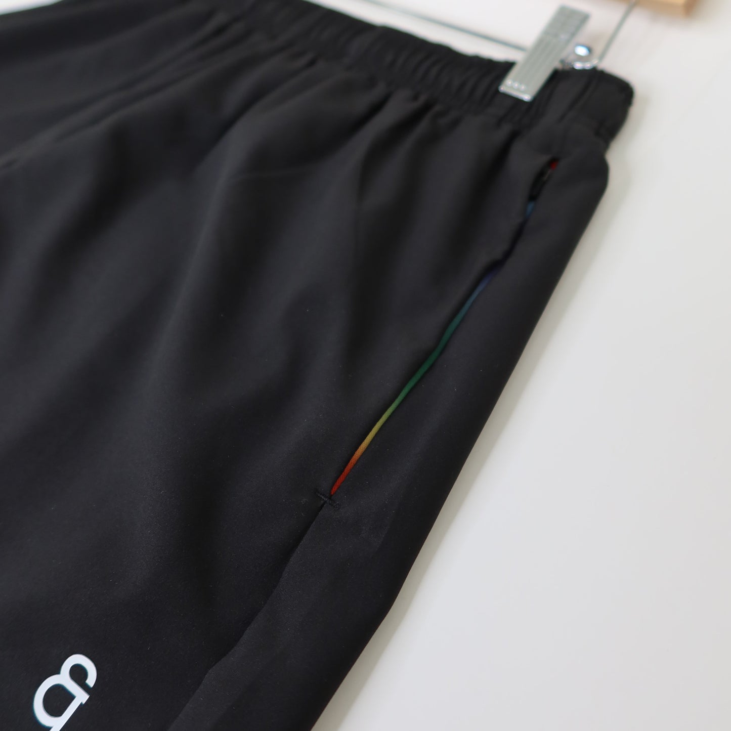 Black pants with a brand logo on a white background