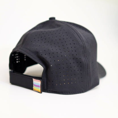 Black cap with a small colorful label on a white background