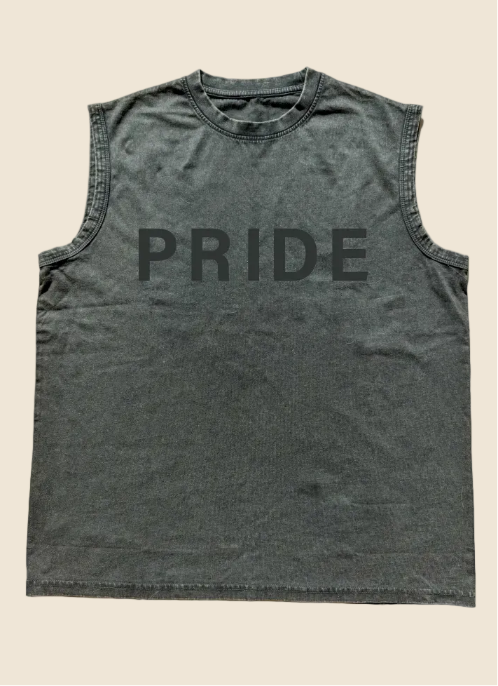 Black sleeveless shirt with 'PRIDE' printed on it, placed on a wooden surface.