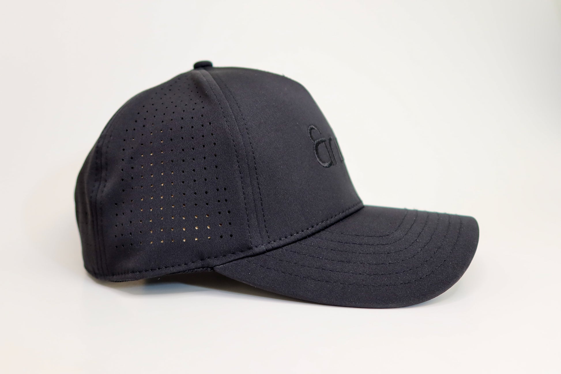 Black baseball cap with a logo on a white background